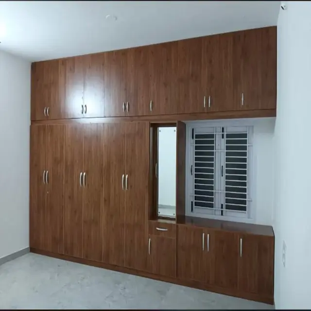Full-wall walnut wardrobe with window niche – Wardrobe by Varnika Furnitures and Aluminium Works, Lucknow